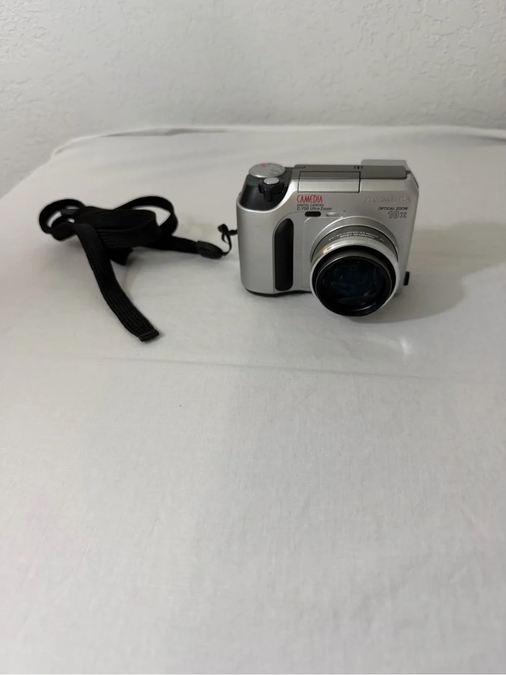 Olympus Silver Compact Digital Camera with Black Wrist Strap